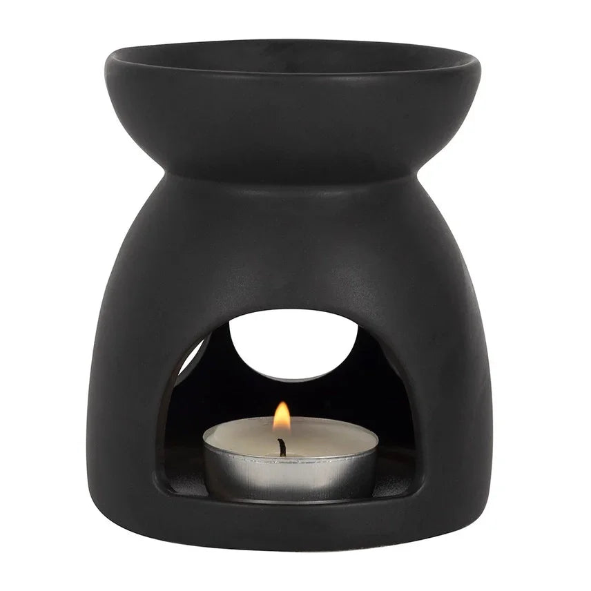 Zwarte keramische waxbrander met theelichtje, ideaal voor aromatherapie en ontspanning.